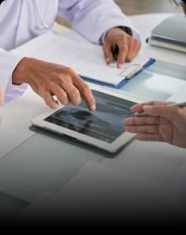 Physician manually reviewing electronic health records and clinical guidelines